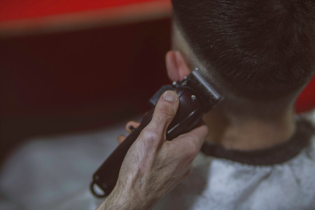 pexels-photo-18503633 Close-up view of a man getting a haircut with clippers, highlighting the precise technique.